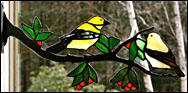 Stained Glass Goldfinches on a branch with berries