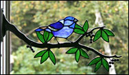 Stained Glass Indigo Bunting on branch with berries